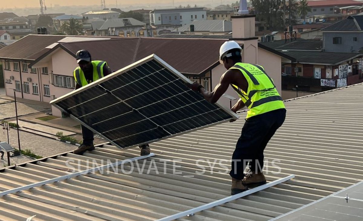 Sunnovate engineers mounting a solar panel on a metal roof